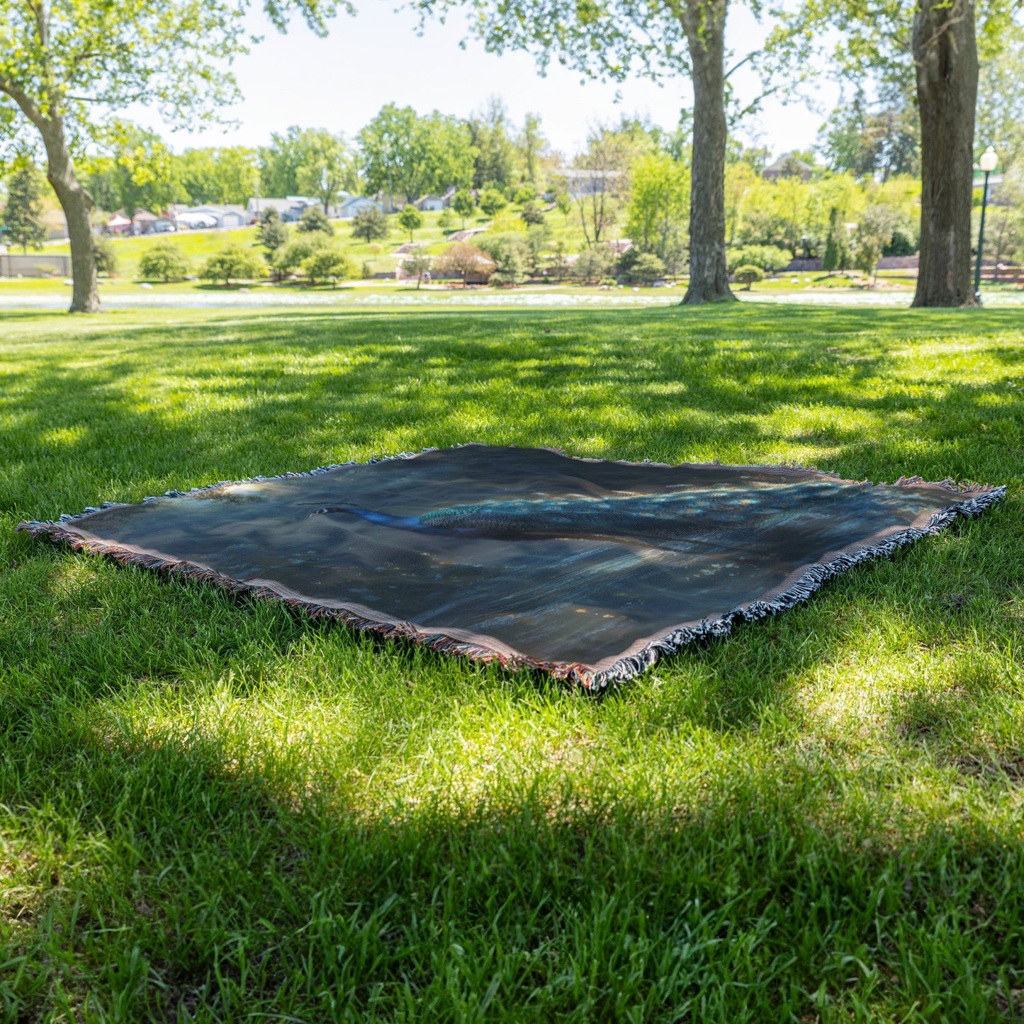 Peacock with Glowing Iridescent Feathers by Crystal Clear Pond Reflection Shimmering Under Twilight Sky Woven Throw Blanket - Awakening Righteousness